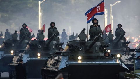 North Korean soldiers ride atop armored vehicles during a military parade in Pyongyang on October 10, 2015.  