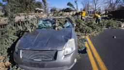 Members of the Colorado Springs Utilities Catamount crew remove a fallen tree that crushed a car driving westbound on Unitah Street in Colorado Springs, Colo., as wind gusts reached more than 100 mph in the Pikes Peak Region on Dec. 15, 2021. The driver and passenger were transported to a local hospital.