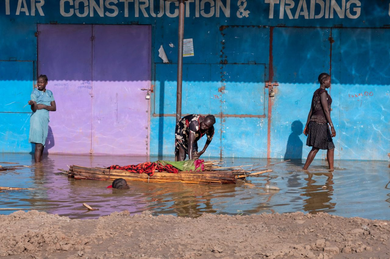 A woman and girl move what's left of their home through what used to be a road in Bentiu.