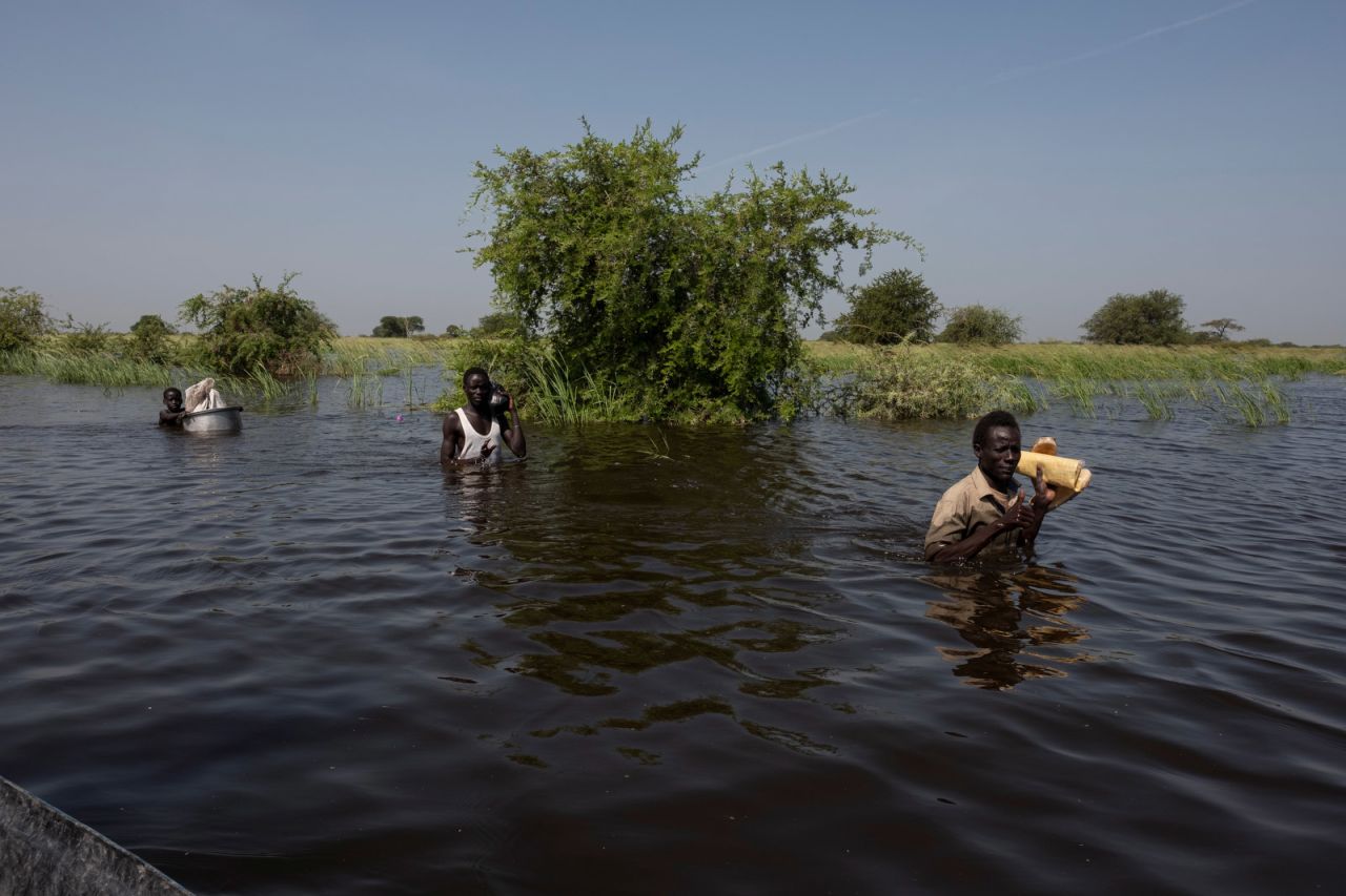 A family moves through floodwaters to buy goods in a part of Bentiu that is on higher ground. Their return journey is some 24 kilometers (about 14.9 miles).