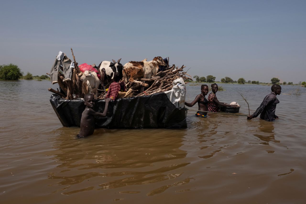 A family pulls their possessions and livestock on a homemade raft. Rich met this family after they had traveled 20 kilometers (about 12.4 miles). They were tired and hungry, Rich said, and the father in the family told him: "Only 5 kilometers (3.1 miles) to go."