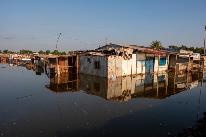 Buildings in Bentiu are submerged in water. Many people are displaced and living in shelters made from sticks and trash.