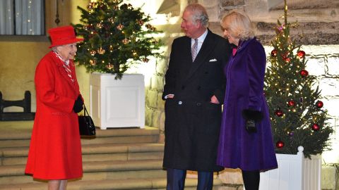 The Queen, Prince Charles and Camilla talk in the quadrangle of Windsor Castle on December 8, 2020 as they wait to thank key workers for their work during the coronavirus pandemic and over Christmas.