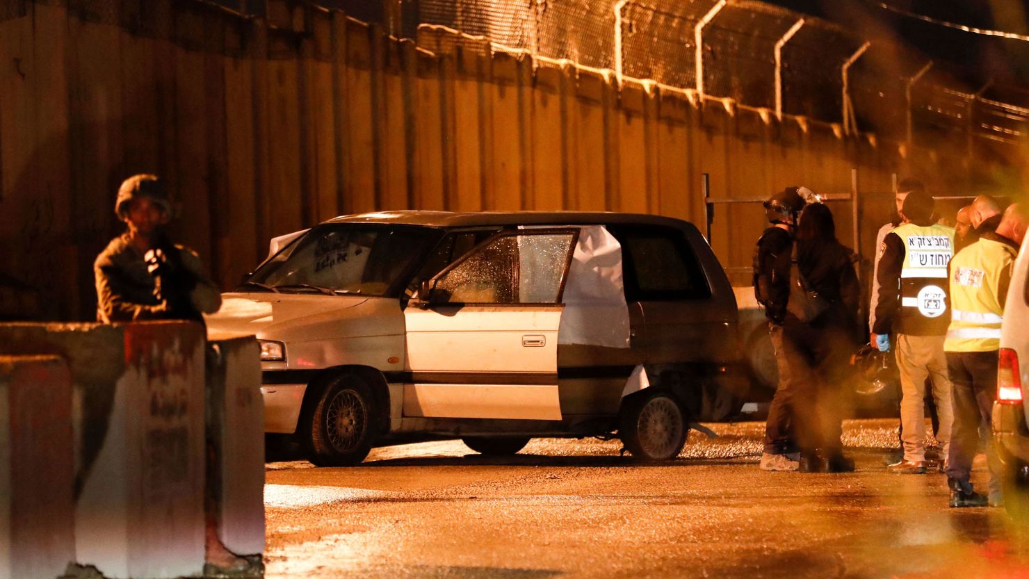 Israeli security forces inspect a car that came under gunfire near a settlement in the  West Bank on December 16, 2021.