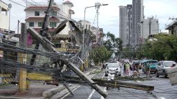 Toppled electrical posts lie along a street in Cebu city, central Philippines caused by Typhoon Rai on Friday, Dec. 17, 2021. A powerful typhoon slammed into the southeastern Philippines on Thursday, toppling trees, ripping tin roofs and knocking down power as it blew across island provinces where nearly 100,000 people have been evacuated.