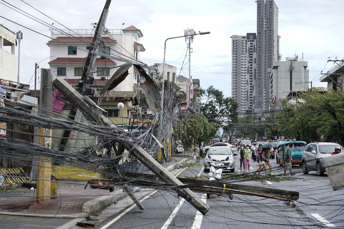 Toppled electrical posts lie along a street in Cebu city, central Philippines, caused by Typhoon Rai.