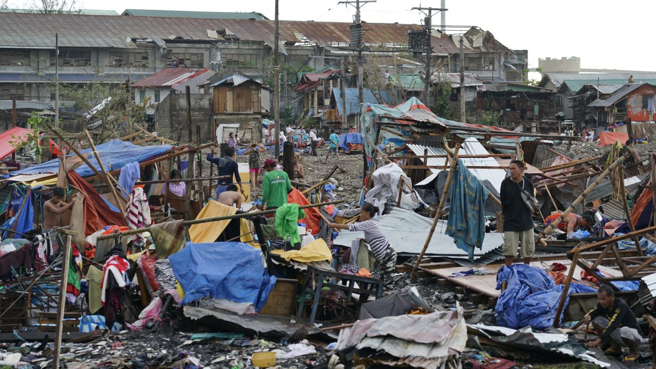 Residents salvage what's left of their damaged homes following Typhoon Rai in Cebu, central Philippines on December 17, 2021.