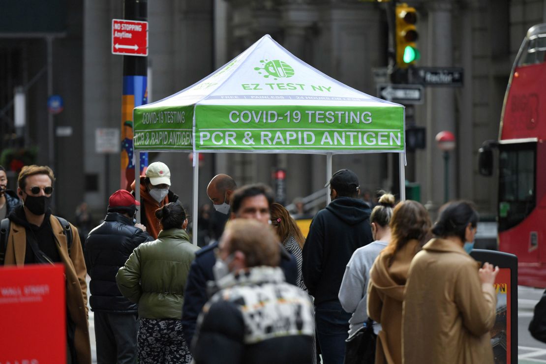 People wait in line to receive a Covid-19 test at a mobile testing site in Manhattan on December 8, 2021.