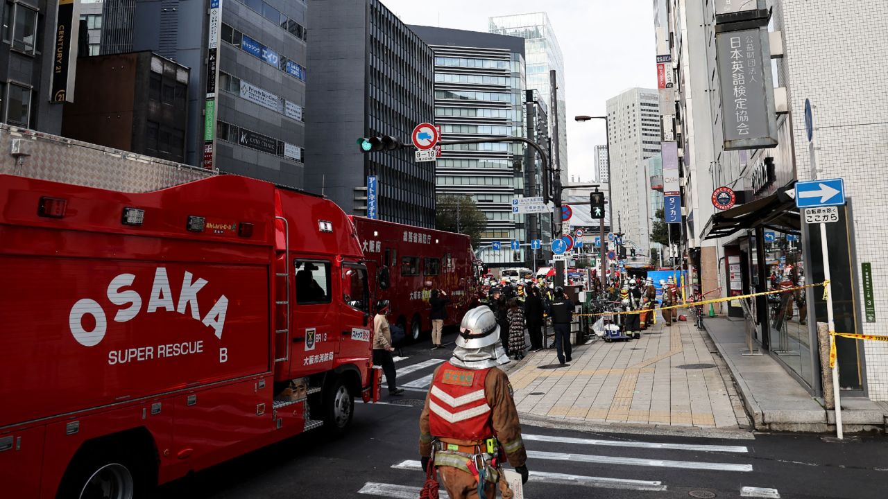 Firetrucks are seen in front of a building, where a fire broke out in Osaka on December 17, 2021.