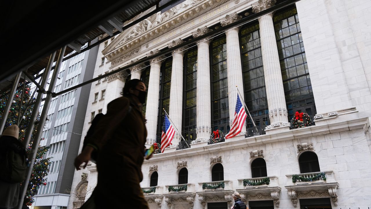 People walk by the New York Stock Exchange (NYSE) on December 13, 2021 in New York City.