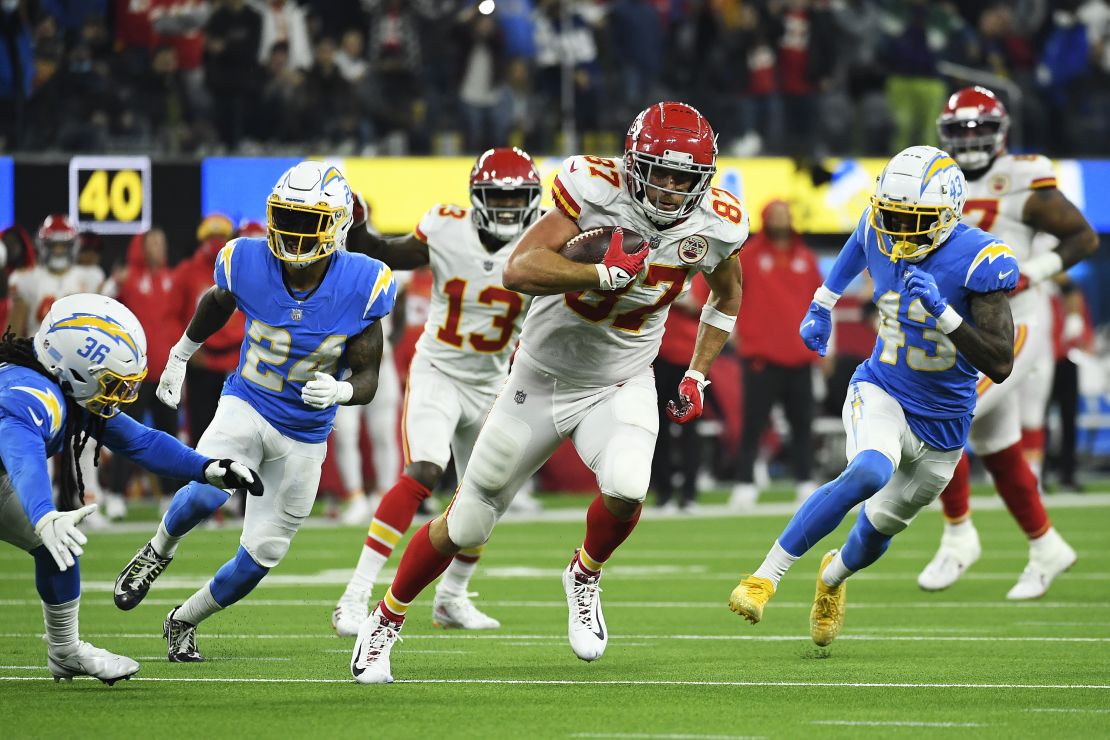 Kelce carries the ball for the touchdown during overtime against the Chargers.