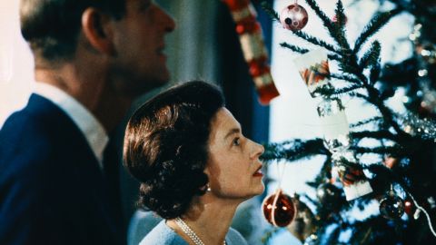 Queen Elizabeth II and Prince Philip put finishing touches to their Christmas tree at Windsor Castle in a still from a 1969 documentary. 
