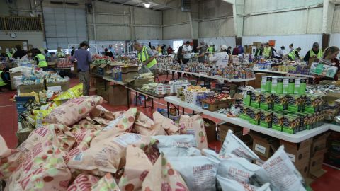 Food, clothes and other supplies are organized at a supply center in Mayfield on December 15.