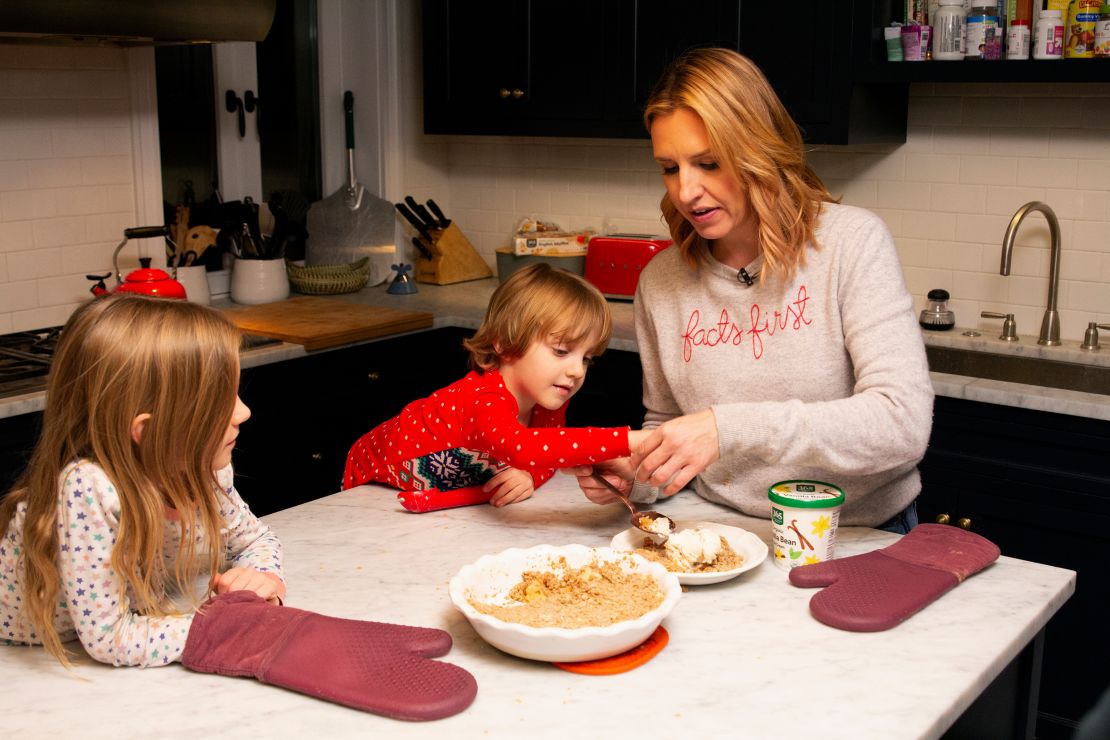 CNN anchor Poppy Harlow (far right) tastes the apple crisp to make sure it's cool enough to eat. 