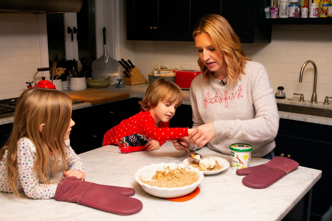 CNN anchor Poppy Harlow (far right) tastes the apple crisp to make sure it's cool enough to eat.