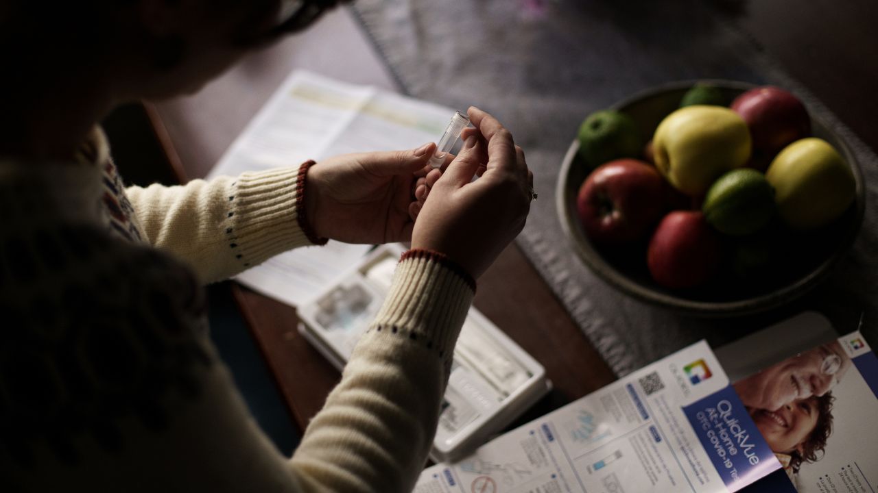 A resident prepares to take a self-administered at-home Covid-19 test, received through a government program, in Easton, New Hampshire.