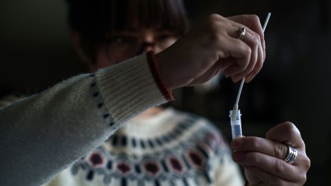 A New Hampshire resident processes a self-administered at-home Covid-19 test on December 7.