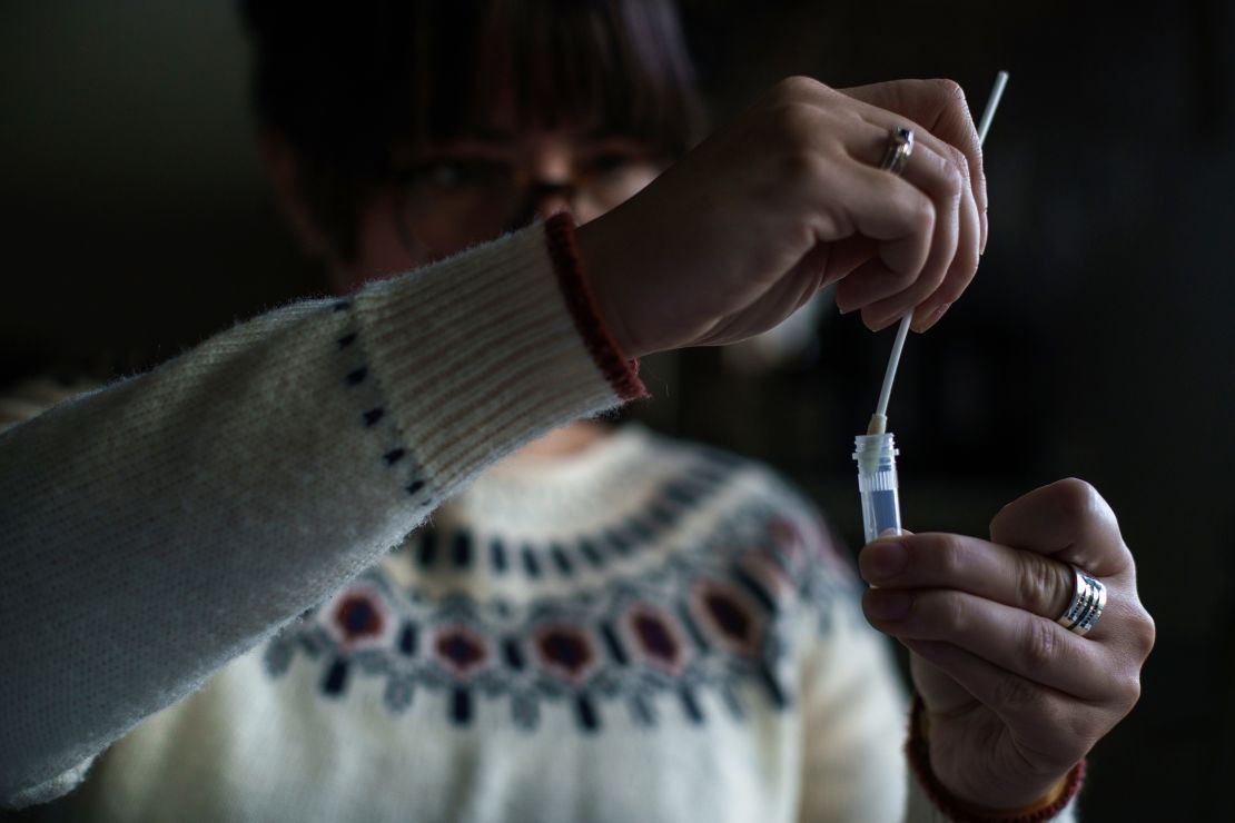 A New Hampshire resident processes a self-administered at-home Covid-19 test on December 7.