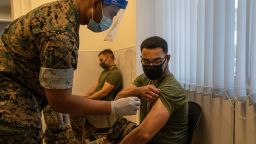 A United States Marine prepares to receive the Moderna coronavirus vaccine at Camp Hansen on April 28, 2021 in Kin, Japan. A United States military vaccination program aiming to inoculate all service personnel and their families against Covid-19 coronavirus is under way on Japans southernmost island of Okinawa, home to around 30,000 US troops and one of the largest US Marine contingents outside of mainland USA.