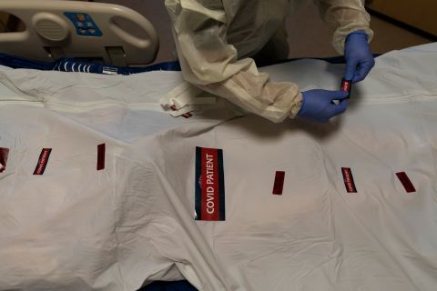 Registered nurse Bryan Hofilena attaches stickers on the body bag of a Covid-19 victim at a Los Angeles hospital on December 14.