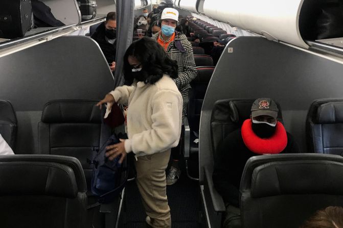 Travelers prepare to get off an American Airlines flight in Washington, DC, on December 18.  