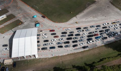 Cars line up at a drive-thru testing site at Miami's Tropical Park on December 17.