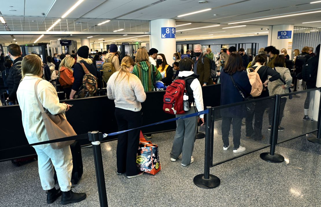 Holiday travelers wait in line for their TSA screening at Los Angeles International Airport on Thursday, December 16, 2021.
