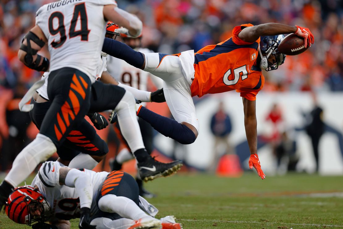 Teddy Bridgewater of the Denver Broncos dives while running the ball and is injured after hitting the ground during the third quarter against the Cincinnati Bengals at Empower Field At Mile High on Sunday.