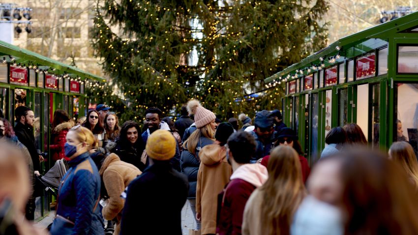 Shoppers walk through the Urbanspace Holiday Shops at Bryant Park in New York, on Dec. 12, 2021.