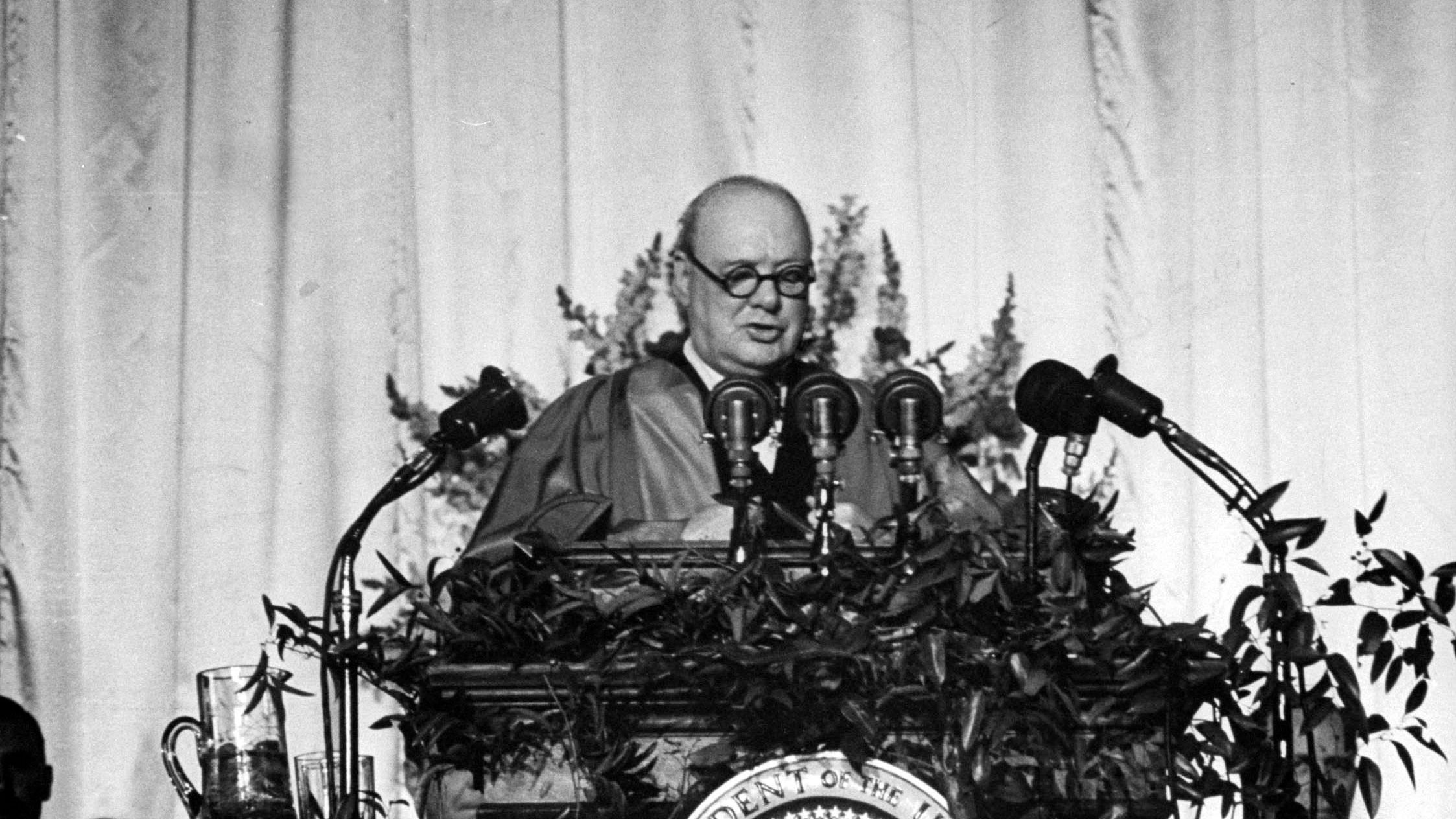British Prime Minister Winston Churchill delivers a speech at Westminster College in Fulton, Missouri, on March 5, 1946. "From Stettin in the Baltic to Trieste in the Adriatic, an Iron Curtain has descended across the Continent," he declared.