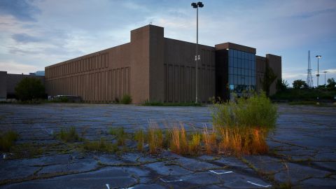 Weeds grow through cracks in the parking lot of the mostly shuttered Metrocenter Mall in South Jackson. Stores in the city's only mall closed one by one before the shopping center finally shut for good in 2018.