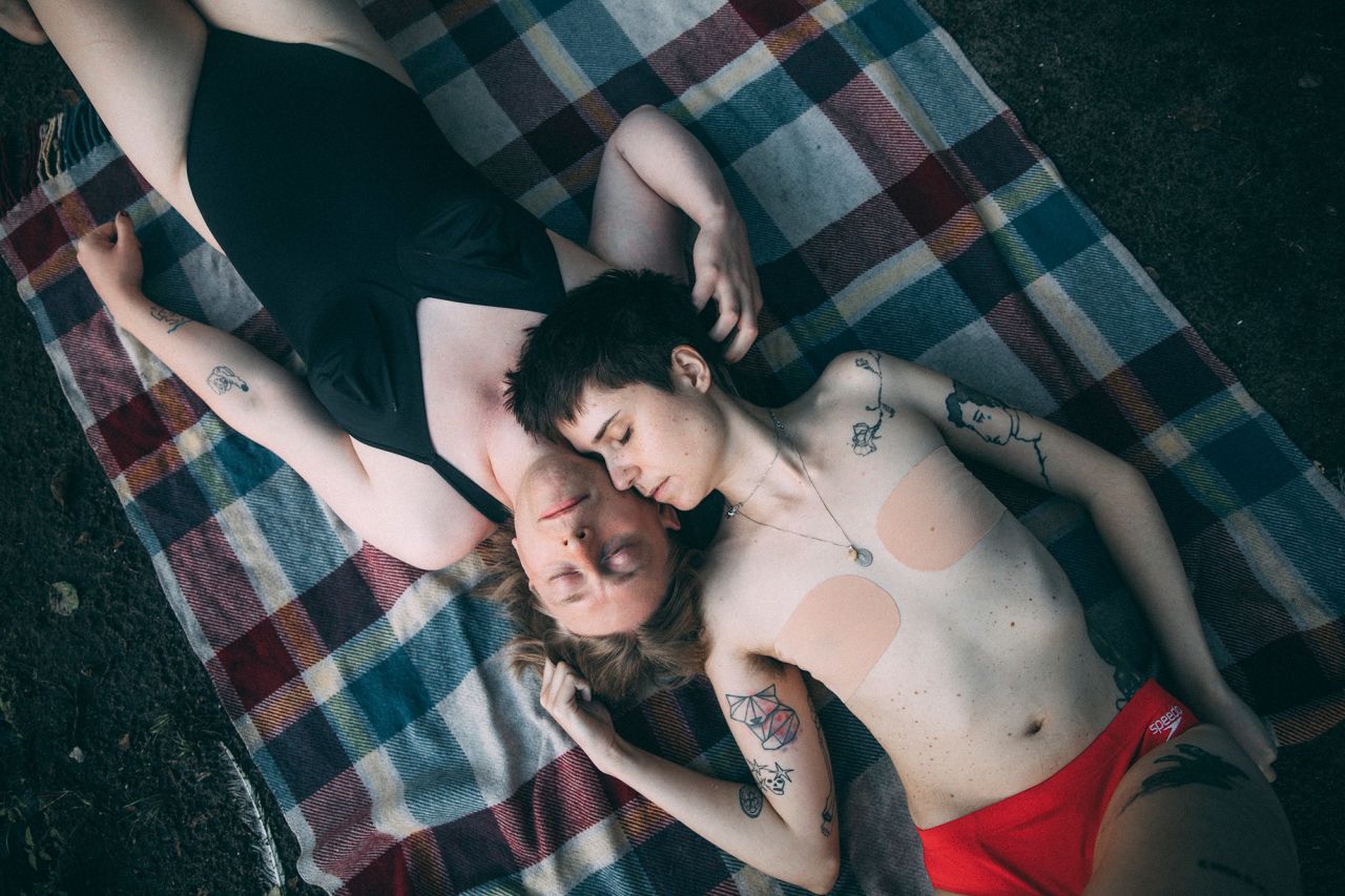 <strong>Marlena Waldthausen, based in Amsterdam, Netherlands, and Berlin, Germany: </strong>Max (dark hair) and Alex (blond) are lying on a blanket on the shore of Krumme Lanke in the southwest of Berlin, Germany. They are both trans, in their early 30s, got married at the beginning of the pandemic, and wanted to work with me for a series I was contributing to on the daily lives of couples in different parts of the world.<br /> <br />'The life of trans people is so invisible in public. And most of the stories that do reach a wider audience are about loneliness and pain,' Max said. So, I aimed to show their relationship outside those stereotypes — simply as a relationship between two people.<br /> <br />I love the tenderness of their gestures in the picture. It´s like you can almost feel Alex´s fingers going though Max´s hair and feel the breath on Alex´s cheek. I´ve always been fascinated by how pictures can capture the intimacy of relationships.