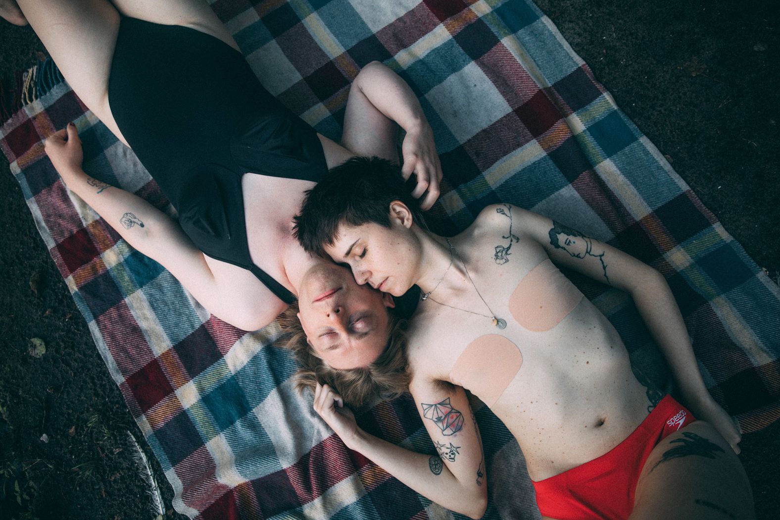 <strong>Marlena Waldthausen, based in Amsterdam, Netherlands, and Berlin, Germany: </strong>Max (dark hair) and Alex (blond) are lying on a blanket on the shore of Krumme Lanke in the southwest of Berlin, Germany. They are both trans, in their early 30s, got married at the beginning of the pandemic, and wanted to work with me for a series I was contributing to on the daily lives of couples in different parts of the world.<br /> <br />'The life of trans people is so invisible in public. And most of the stories that do reach a wider audience are about loneliness and pain,' Max said. So, I aimed to show their relationship outside those stereotypes — simply as a relationship between two people.<br /> <br />I love the tenderness of their gestures in the picture. It′s like you can almost feel Alex′s fingers going though Max′s hair and feel the breath on Alex′s cheek.?I′ve always been fascinated by how pictures can capture the intimacy of relationships.