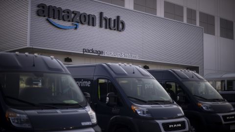 Delivery vans parked outside the package pick-up and returns area of an Amazon fulfillment center in Denver, Colorado, U.S., on Tuesday, Sept. 28, 2021. 