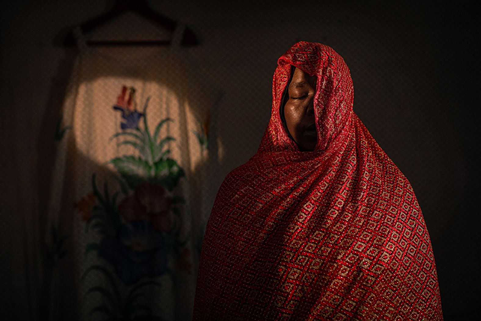 <strong>Fatma Fahmy, based in Cairo, Egypt:</strong> This photograph is part of a project of mine looking deeply into the lives of women refugees, each of whom I spent a month getting to know. Refugees are often running from war, but they still have battles to fight in host countries such as loneliness, fear, isolation, fragility, sadness. Then they faced the pandemic.<br /> <br />Khwater, 35, is from the north of Sudan. She sought refuge in Egypt to be with her sister. The Covid-19 pandemic was hard for her financially, mentally, and physically, but being with her sister made it much more manageable.?But then Khwater's sister died of cancer. After her sister's death, Khwater said: 'The world stopped for me. It was the most challenging time ever. I wish for everyone to exploit every moment with their siblings as separation is very hard.'<br /> <br />Khwater's story and her journey touches my heart. When I think of myself and what's happened to me during the pandemic, listening to the stories of women like Khwater has given me the power to continue to live and to tell stories.