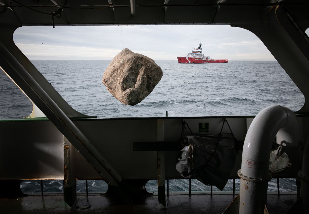 <strong>Suzanne Plunkett, based in London:</strong> This image shows a boulder plummeting past a window on board the Greenpeace ship, Esperanza, in the English Channel. These boulders are carefully deployed to deter <a href="https://www.cnn.com/2021/12/13/world/seahorses-bottom-trawling-amanda-vincent-c2e-spc-intl/index.html" target="_blank">destructive industrial "bottom trawlers"</a> from breaching fishing bans in designated Marine Protected Areas. In the background, you can see a patrol boat from the UK government's Marine Management Organisation keeping an eye on the Esperanza.<br />   <br />There's only a split second where the boulder appears to hover in the center of the frame, meanwhile the ship is constantly moving, so getting the patrol boat in the frame and the sun at the right angle was a challenge. Keeping the cameras dry was also an issue — I covered my lights with hotel shower caps to spare them from the enormous splash that the stones created.<br />   <br />Collaborating on a campaign that I really care about with an organization at the forefront of tackling environmental issues makes me feel very proud and motivated to capture eye-catching photographs that create awareness of how fragile our planet is and what needs to be done to protect it.