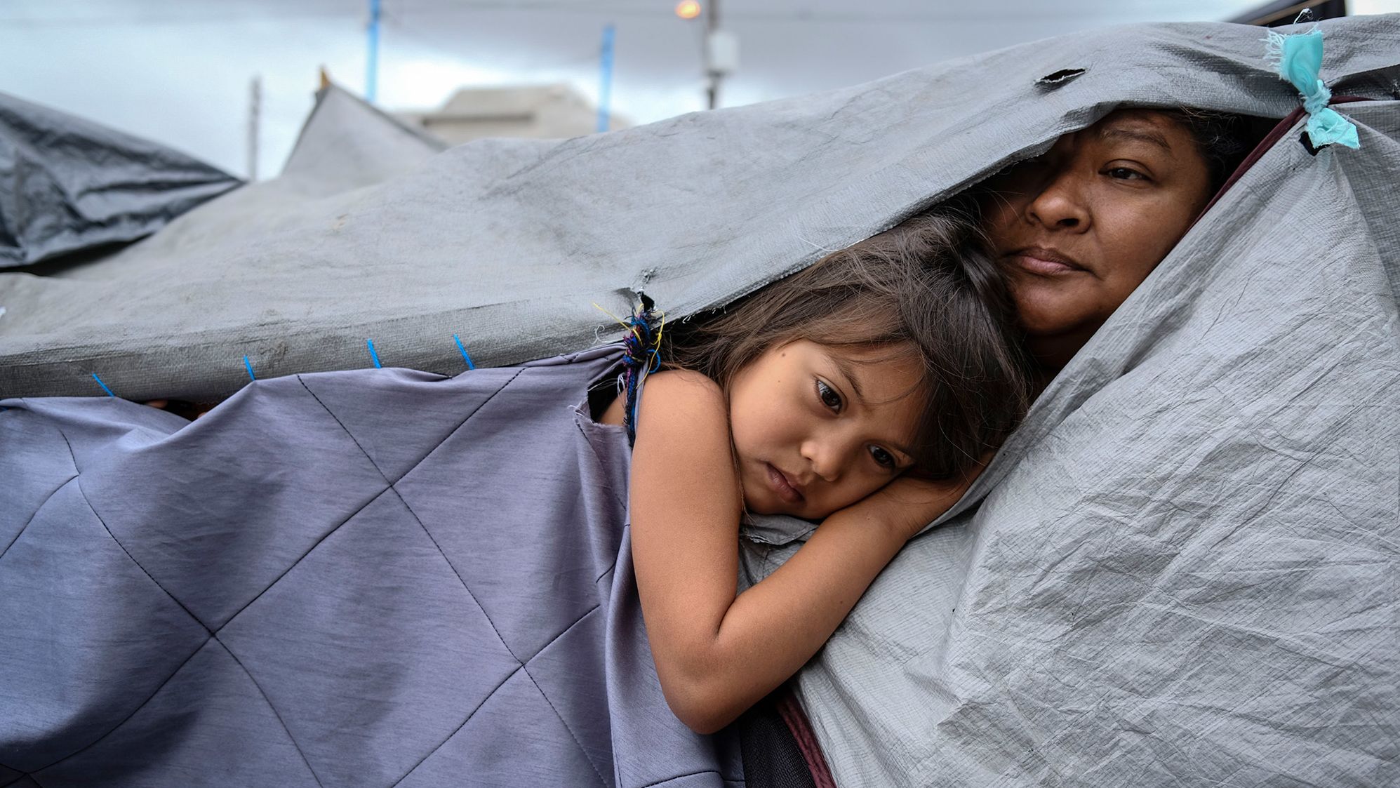 <strong>Toya Sarno Jordan, based in Mexico City, Mexico:</strong> Kami, 5, and her aunt Mariana, from Honduras, are listening to a discussion about hygiene norms at a makeshift migrant camp at the El Chaparral port of entry with the US in Tijuana, Mexico. The camp began to form after <a href="https://edition.cnn.com/2020/03/20/politics/us-mexico-border/index.html" target="_blank">the US closed its land borders in March 2020</a> due to Covid-19 and has hosted up to around 2000 people from Central and Latin America.<br /> <br />At the time I took the photo, the camp was open to the press and I was able to spend many hours walking around and talking to people, which gave me access to more intimate moments in their daily lives.<br /> <br />What stands out to me is the grace that is found in moments of pause and silence within greater contexts of conflict. I find that in all coverage where there might be explicit violence, uncertainty and insecurity, there is equally beauty and light that define us as a global community.