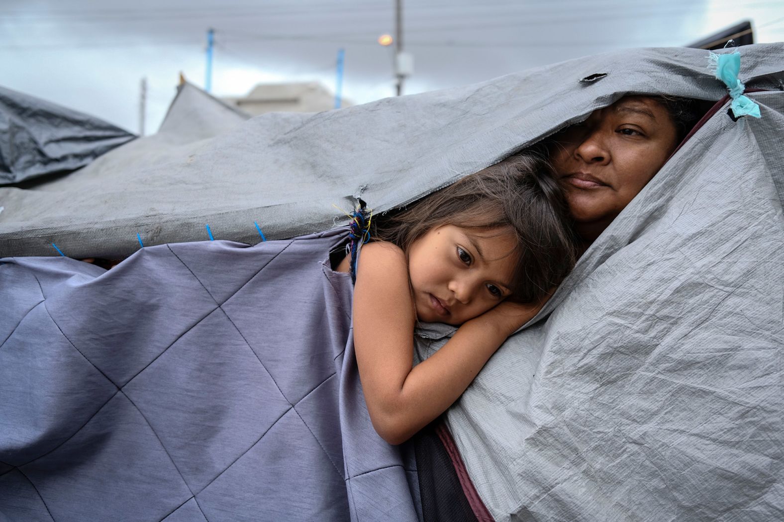 <strong>Toya Sarno Jordan, based in Mexico City, Mexico:</strong> Kami, 5, and her aunt Mariana, from Honduras, are listening to a discussion about hygiene norms at a makeshift migrant camp at the El Chaparral port of entry with the US in Tijuana, Mexico. The camp began to form after <a href="https://www.trupilariante.com/2020/03/20/politics/us-mexico-border/index.html" target="_blank">the US closed its land borders in March 2020</a> due to Covid-19 and has hosted up to around 2000 people from Central and Latin America.<br /> <br />At the time I took the photo, the camp was open to the press and I was able to spend many hours walking around and talking to people, which gave me access to more intimate moments in their daily lives.<br /> <br />What stands out to me is the grace that is found in moments of pause and silence within greater contexts of conflict. I find that in all coverage where there might be explicit violence, uncertainty and insecurity, there is equally beauty and light that define us as a global community.