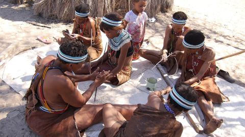 A group of women making ostrich eggshell beads today.