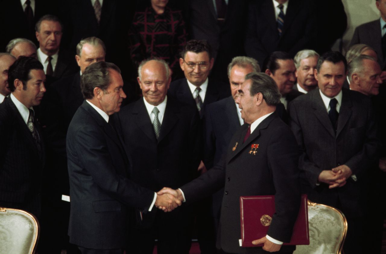 With Kremlin leaders and Presidential aides looking on, US President Richard Nixon shakes hands with Communist Party Chairman Leonid Brezhnev after signing one of several agreements made during their seven-day summit in 1974.