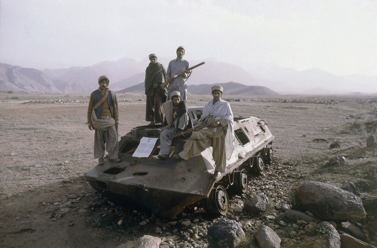 Afghan rebels are seen on top of a knocked out Russian armored vehicle in Afghanistan in February 1980. The Soviet Union invaded Afghanistan in 1979 as communist Babrak Karmal seized control of the government. US-backed Muslim guerrilla fighters waged a costly war against the Soviets for nearly a decade.