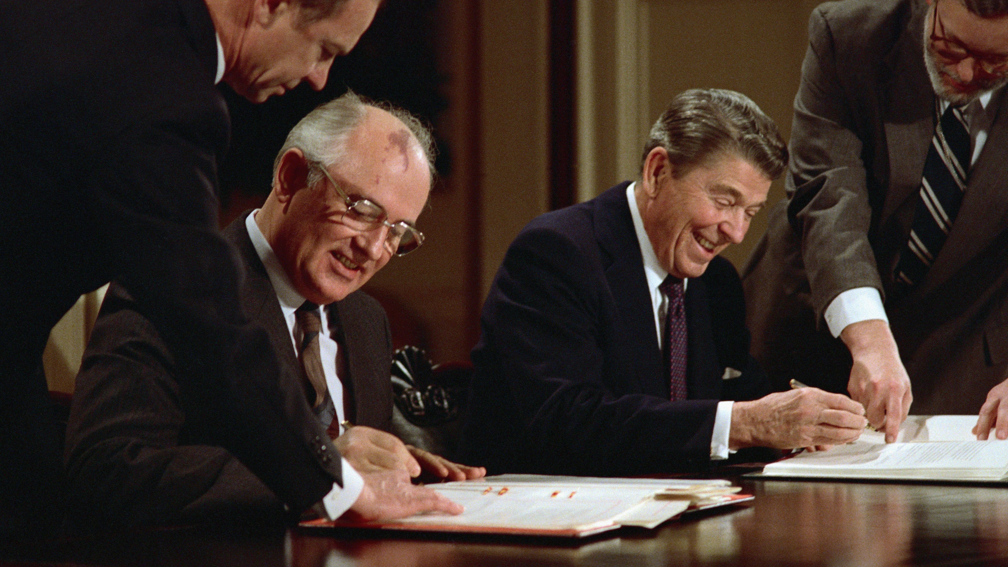 President Reagan and Soviet leader Mikhail Gorbachev sign the arms control agreement banning the use of intermediate-range nuclear missiles in December 1987.