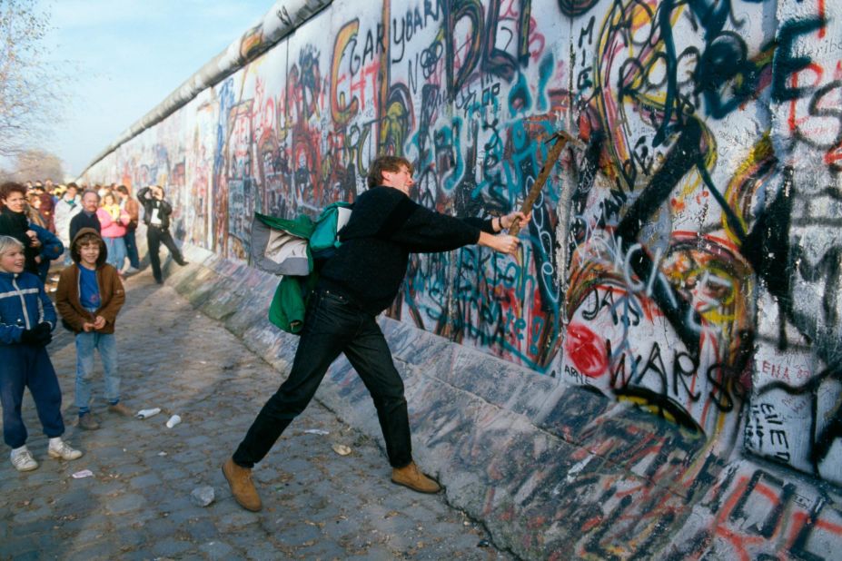 A demonstrator pounds away at the Berlin Wall in November 1989. Gorbachev renounced the Brezhnev Doctrine, which pledged to use Soviet force to protect its interests in Eastern Europe. In September, Hungary opened its border with Austria, allowing East Germans to flee to the West. After massive public demonstrations in East Germany and Eastern Europe, the Berlin Wall fell on November 9.