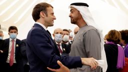 French President Emmanuel Macron (L) is greeted by Abu Dhabi's Crown Prince Mohammed bin Zayed al-Nahyan during his tour of the Emirates pavillion at the Dubai Expo on the first day of his Gulf tour on December 3, 2021. - The UAE signed among other deals today a record, 14-billion-euro contract for 80 French-made Rafale warplanes and committed billions of euros in other agremments as Macron kicked off a Gulf tour that will also take him to Qatar and Saudi Arabia. (Photo by Thomas SAMSON / AFP) (Photo by THOMAS SAMSON/AFP via Getty Images)