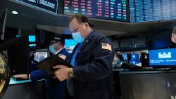A trader works on the floor of the New York Stock Exchange (NYSE) at the start of trading on Monday following Friday's steep decline in global stocks over fears of the new omicron Covid variant on December 20, 2021 in New York City. Stocks fell sharply in morning trading with the Dow falling over 500 points.