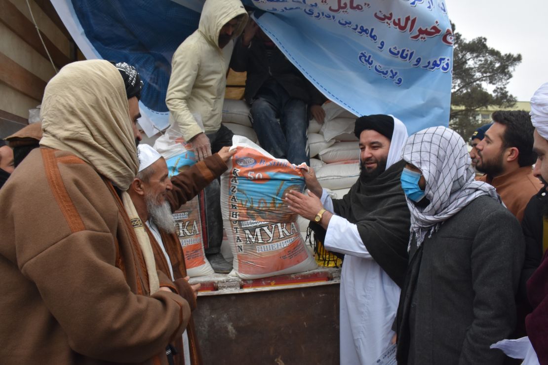 An Afghan teacher receives humanitarian assistance in Mazar-i-Sharif, Balkh province, Afghanistan, on December 15.