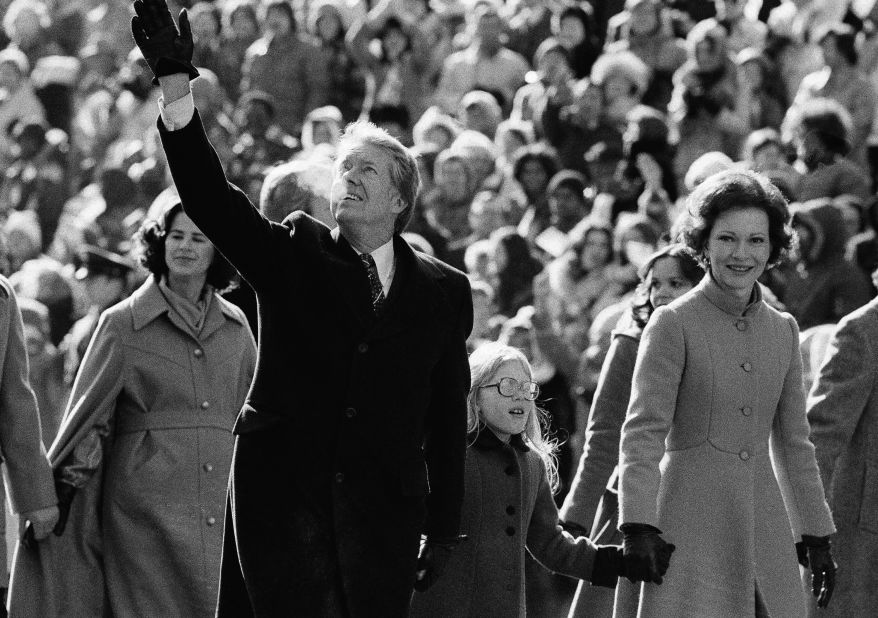 The Carters hold Amy's hand as they walk down Pennsylvania Avenue after the inauguration in January 1977. It was the first time in history that a president had not ridden toward the White House in a carriage or automobile to celebrate taking the oath of office.