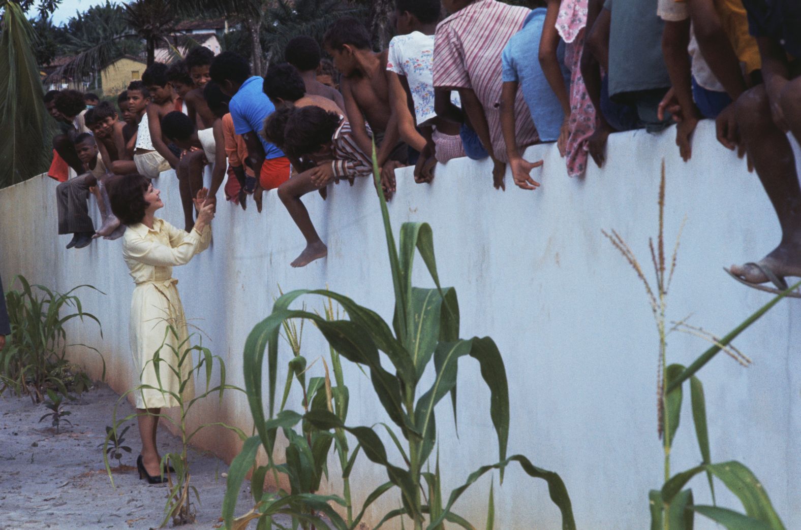 Rosalynn greets children during a trip to Brazil in June 1977.
