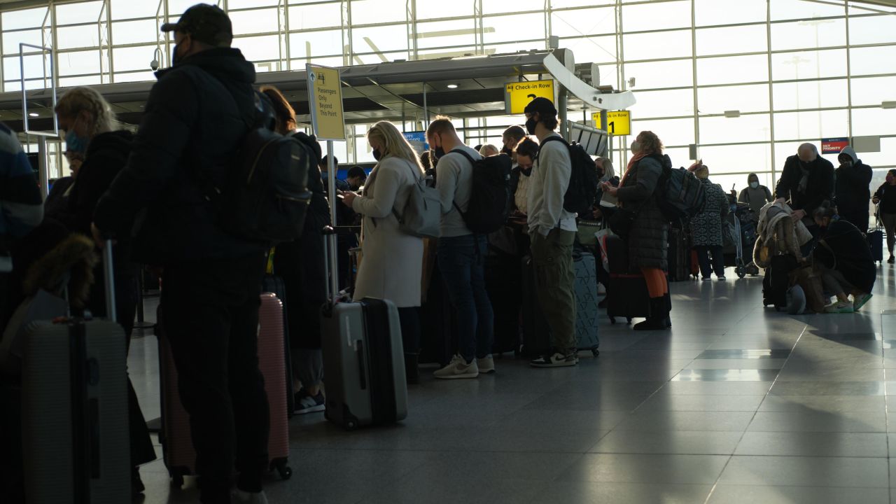 Travelers wait on line December 13 to check in at John F. Kennedy International Airport.