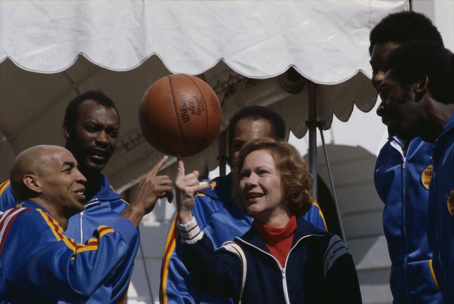 The Harlem Globetrotters help Rosalynn spin a basketball on her finger in March 1980.